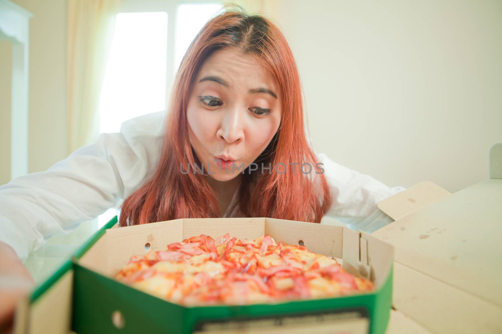 Young asian beautiful woman with pizza at home
