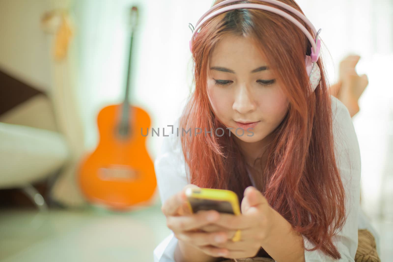 Young asian beautiful woman with smart phone and listening to music