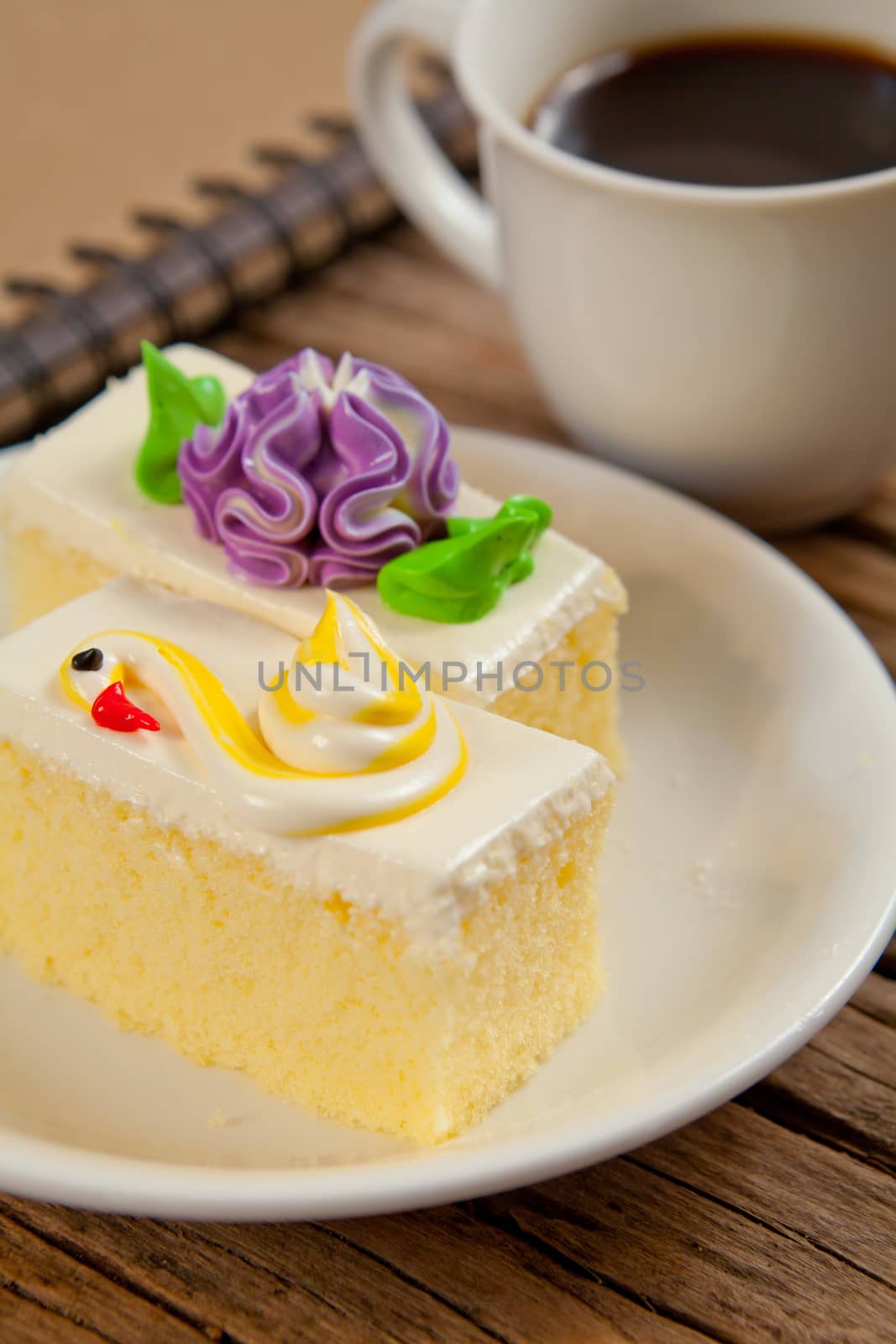 Flower Cake in white dish and coffee on the wood table