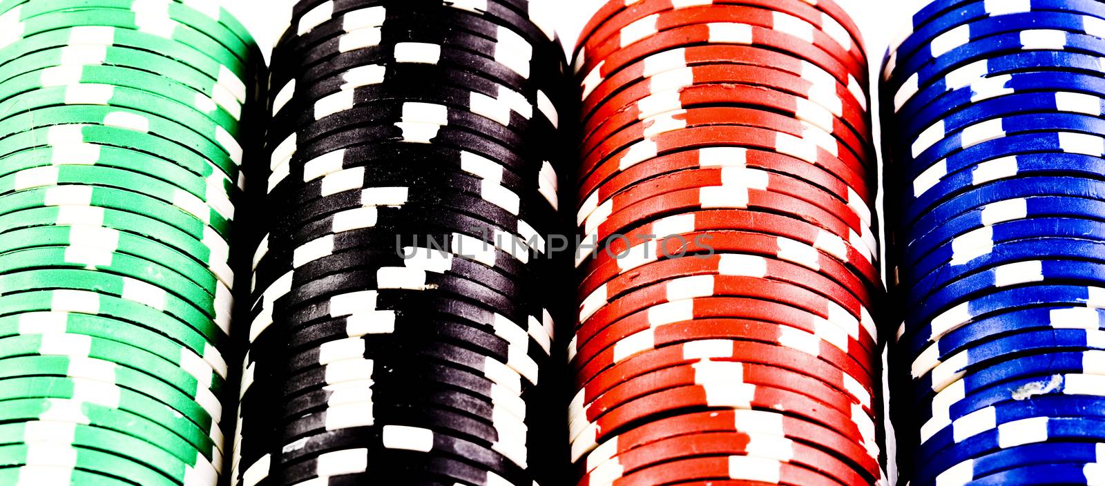 Poker chips in rack colorful and in rows