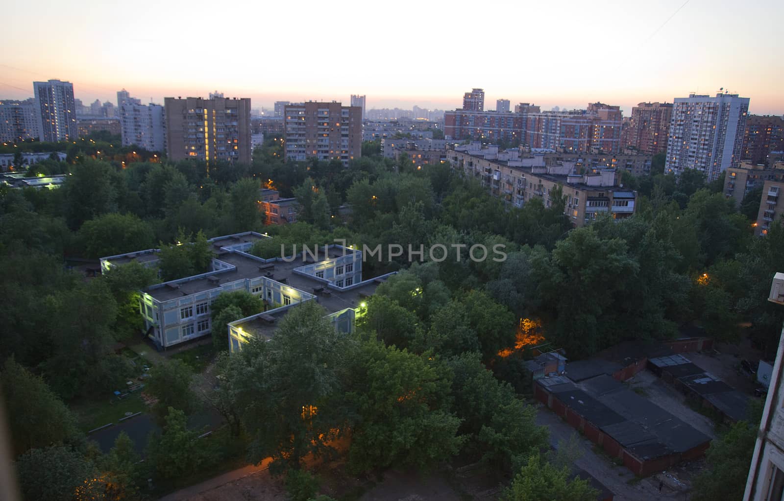 Moscow residental building and green trees in the evening