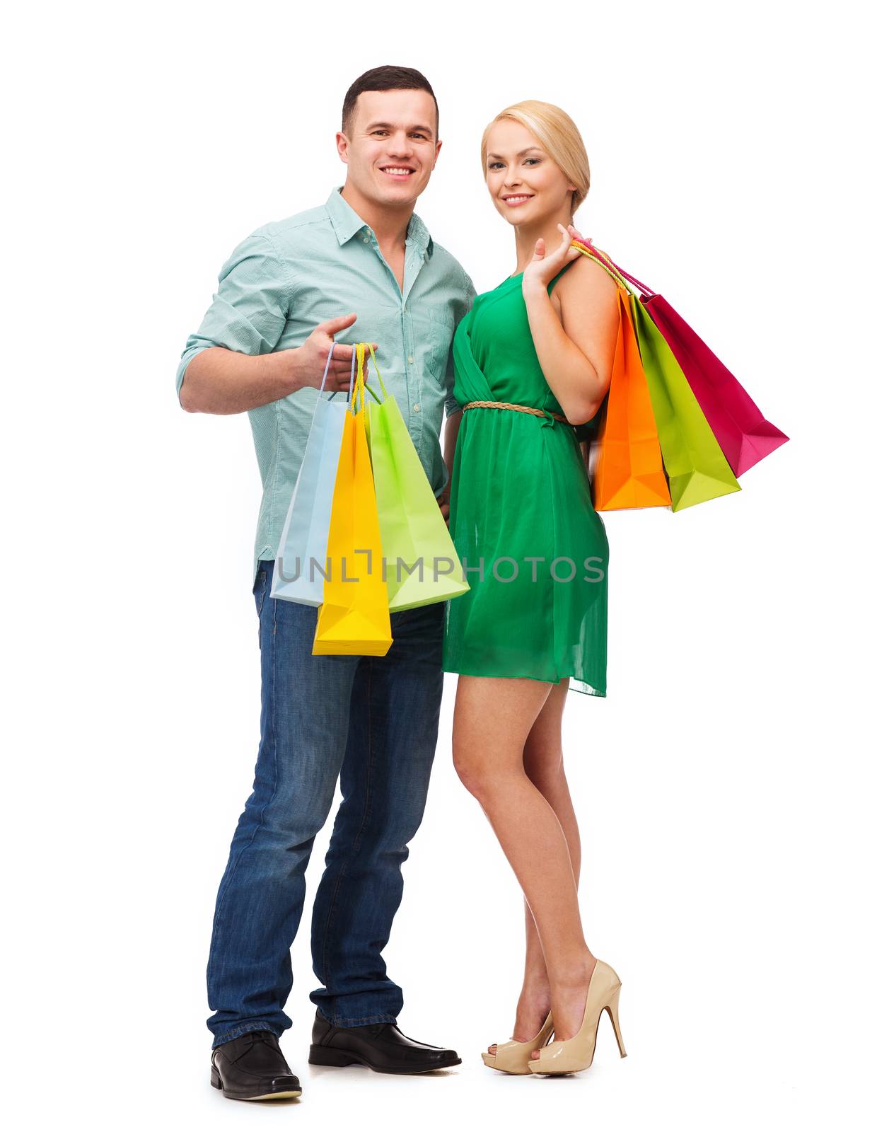 smiling couple with shopping bags by dolgachov