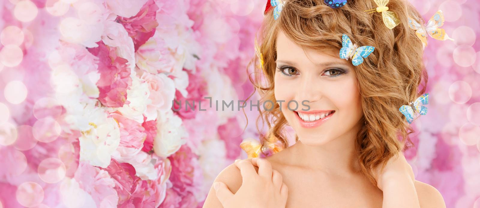 health and beauty concept - happy teenage girl with butterflies in hair