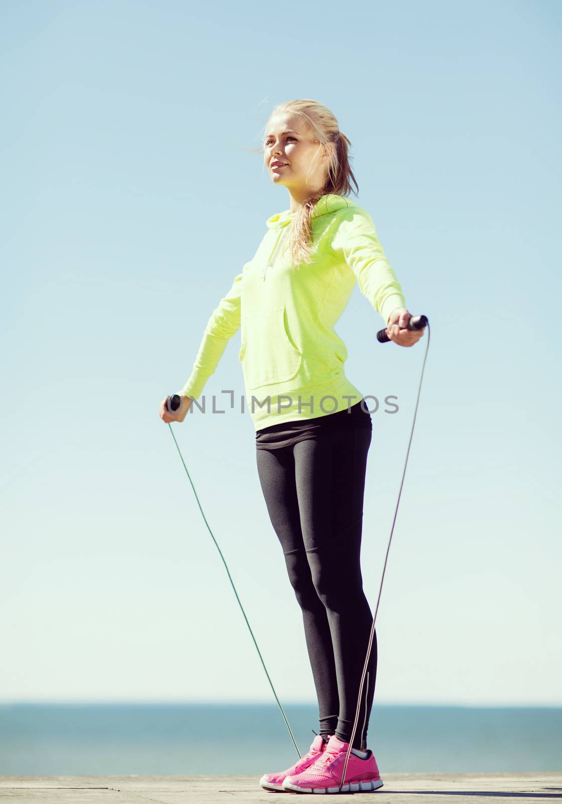 fitness and lifestyle concept - woman doing sports outdoors