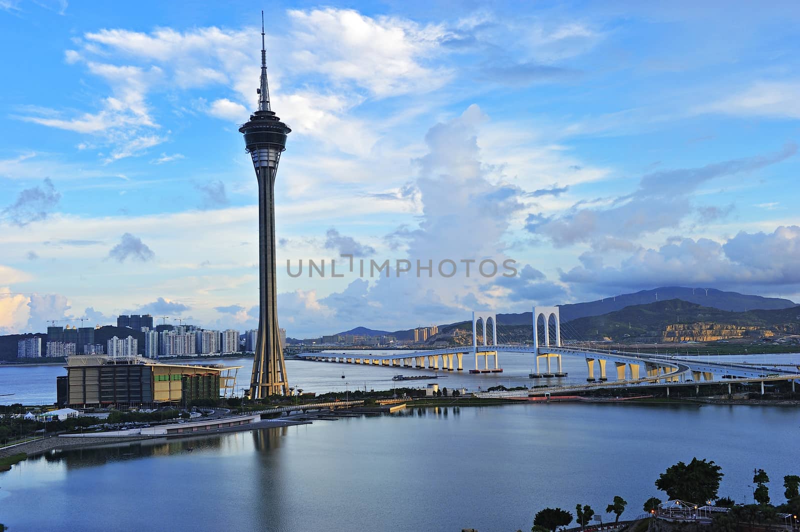 Urban landscape of Macau with famous traveling tower under blue sky near river in Macao, Asia.