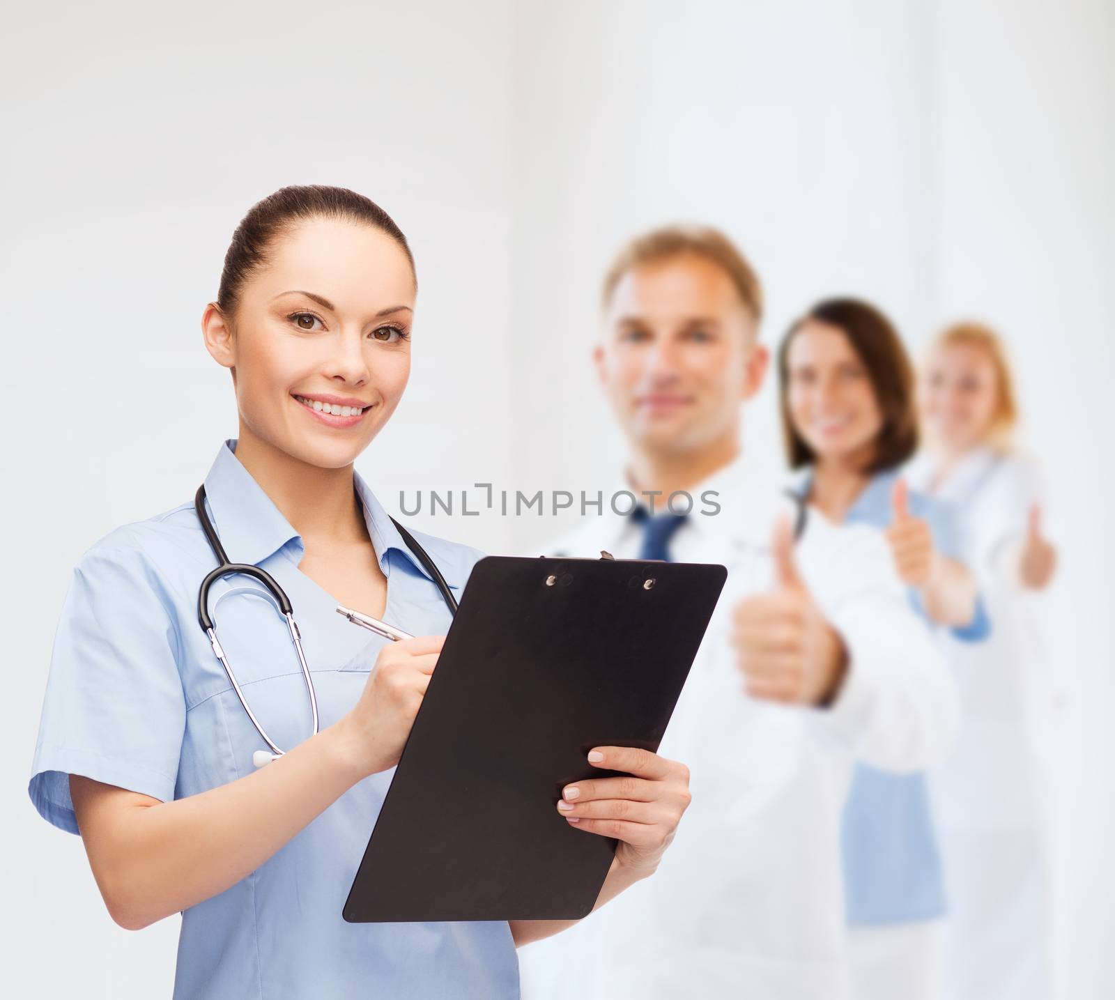 smiling female doctor or nurse with stethoscope by dolgachov