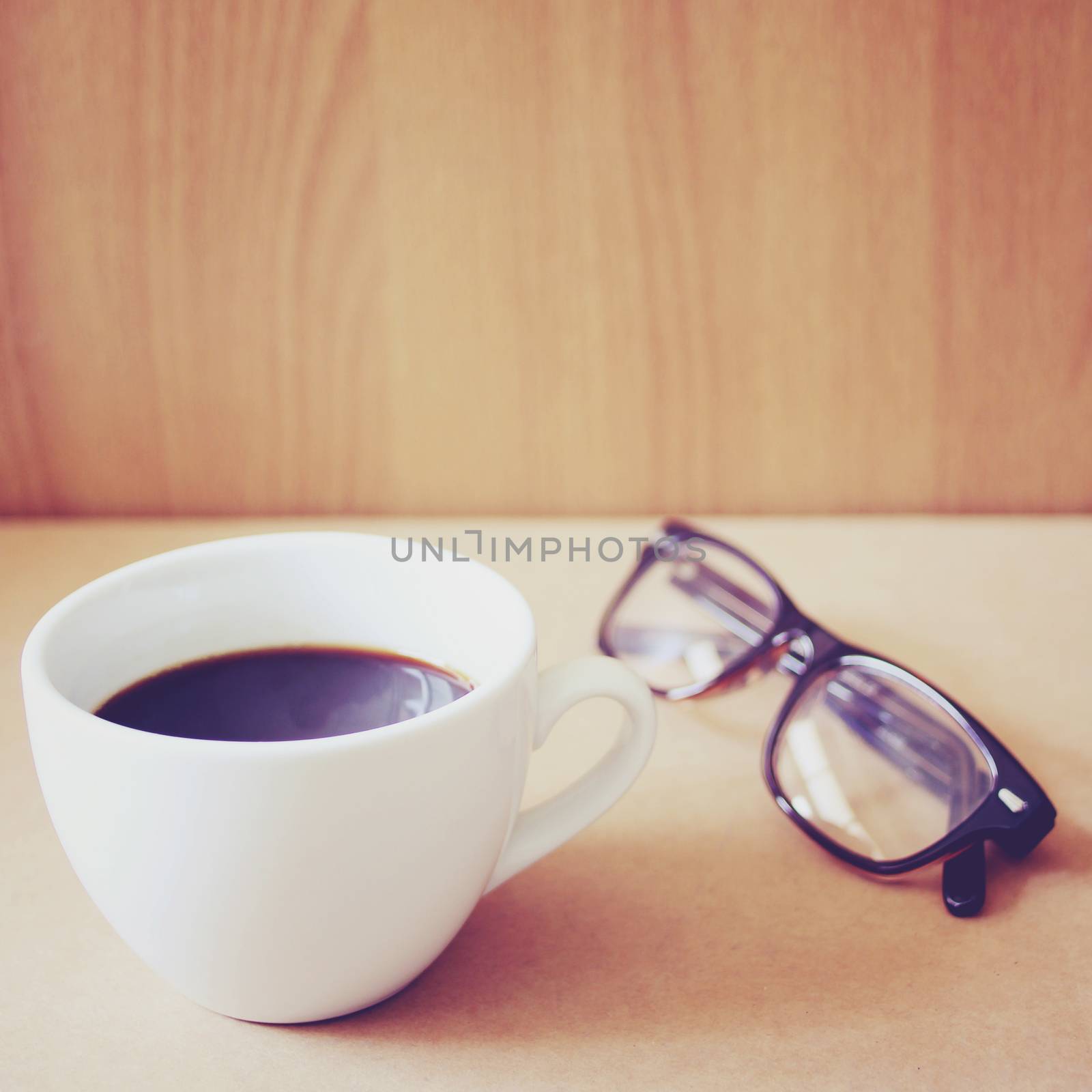 Hot coffee and eyeglasses with retro filter effect by nuchylee