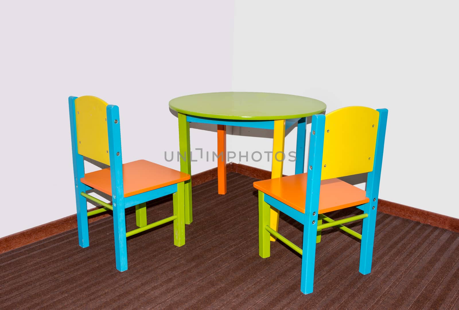 two small school chairs and table in fresh green blue and red