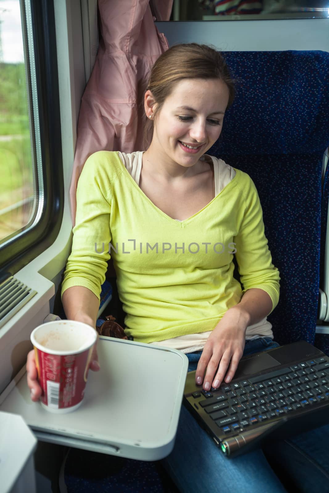 Young woman traveling by train by viktor_cap
