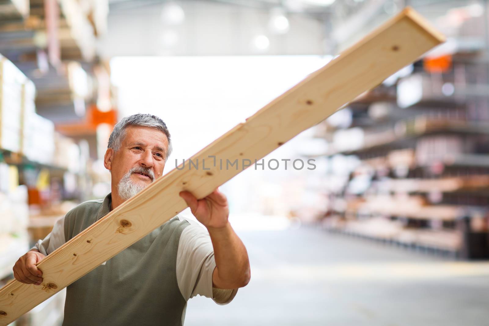 Man buying construction wood in a  DIY store for his DIY home re-modeling project