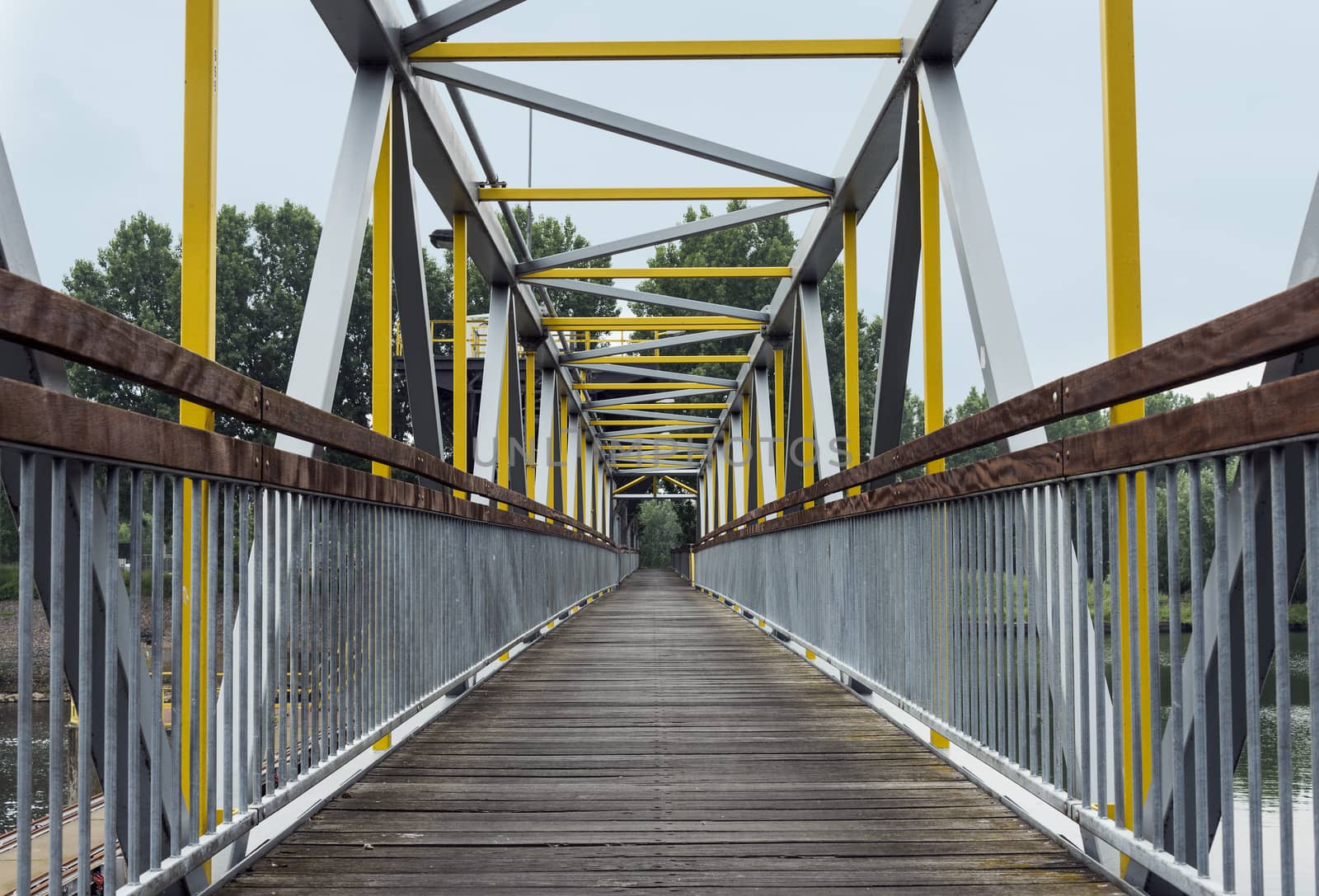 metal bridge crossing the river by compuinfoto