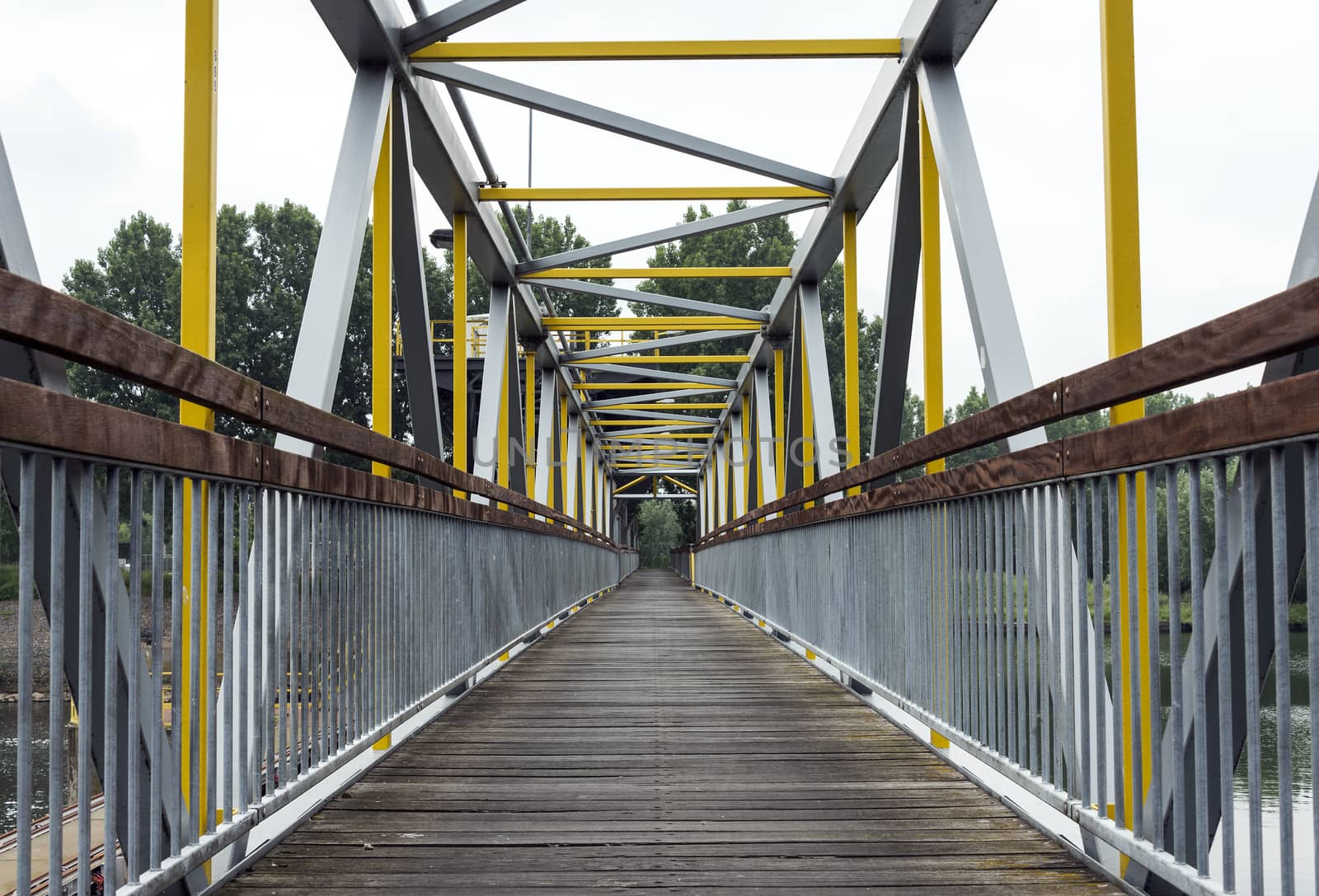 metal bridge crossing the river maas in holland