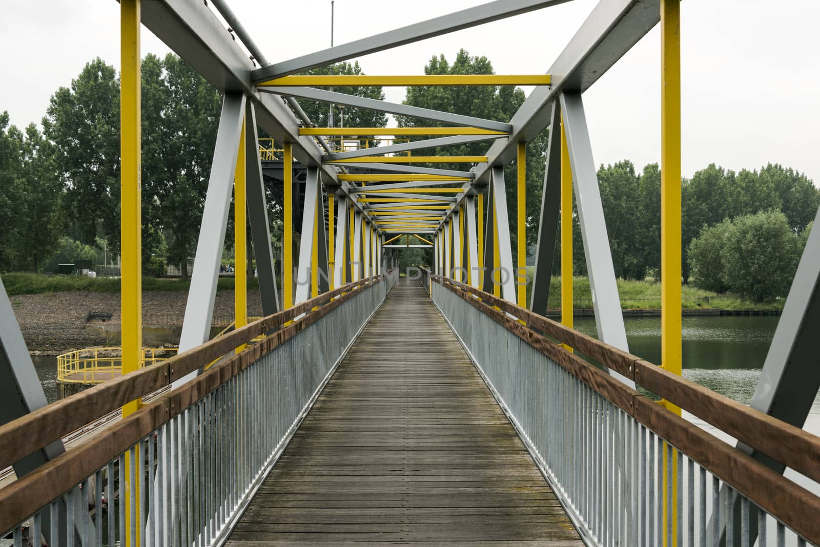 metal bridge crossing the river maas in holland