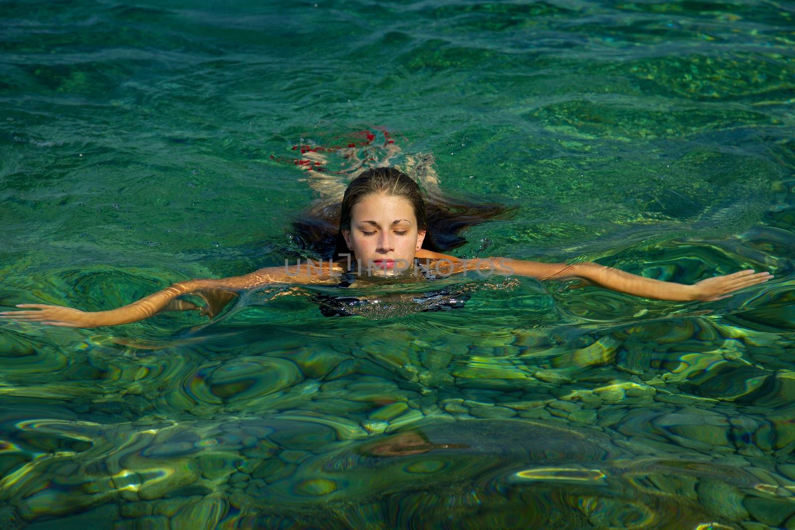 Woman splashing water in the sea