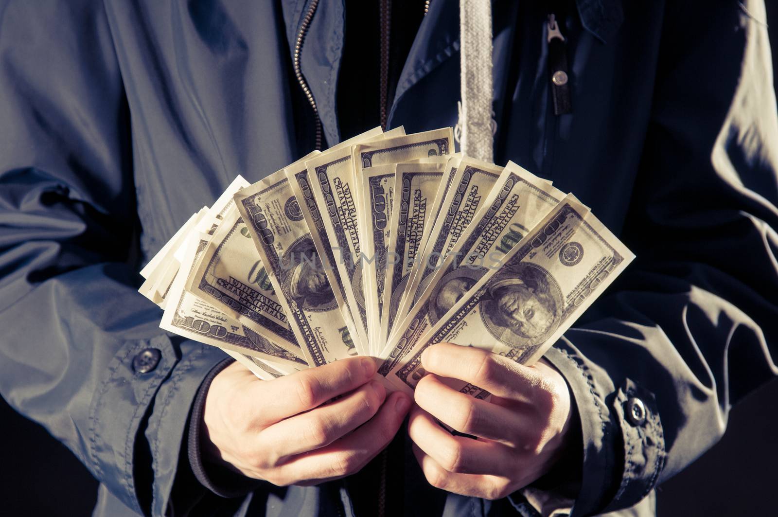 young man holding cash in hands
