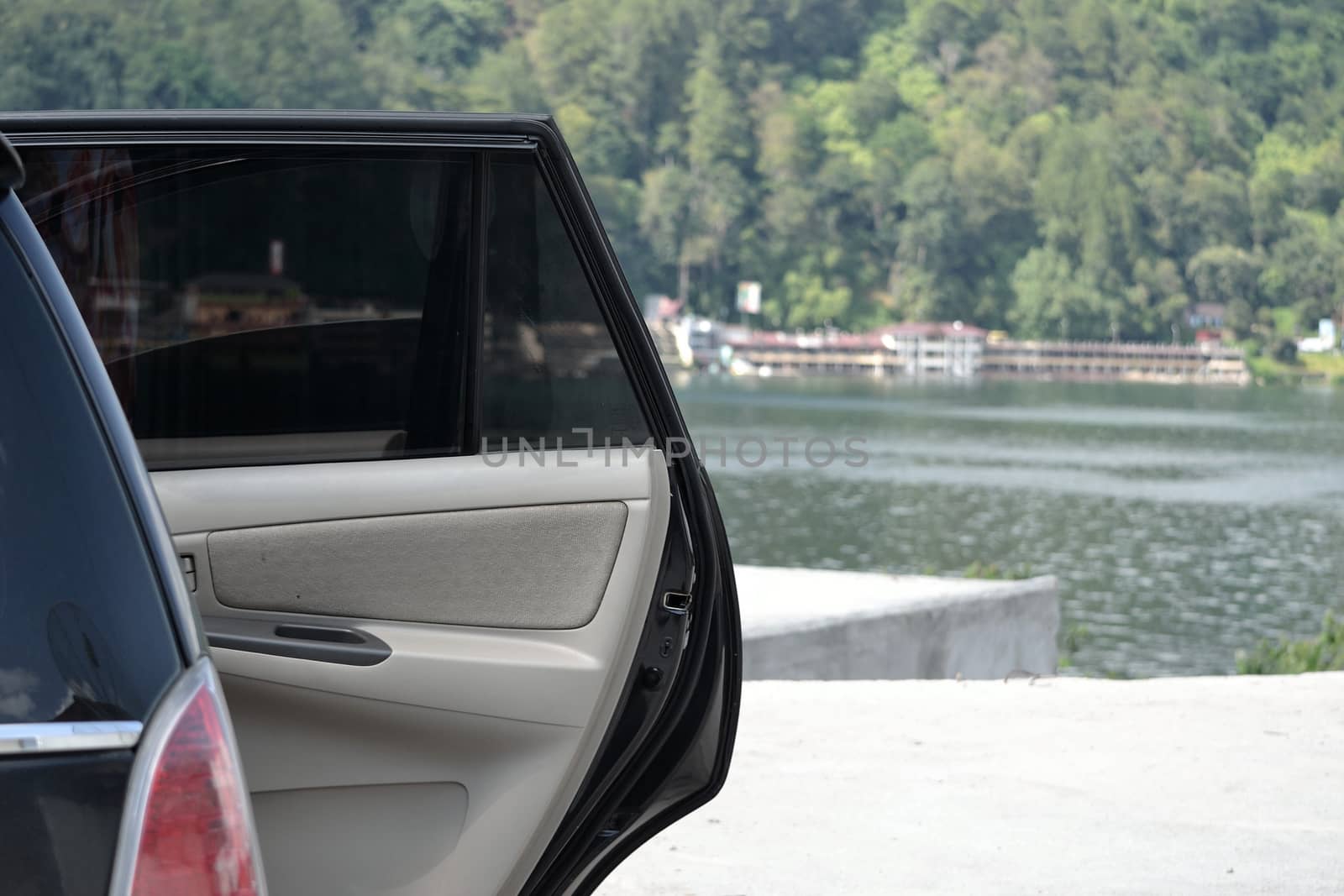 black car door opened while parking at the side of lake