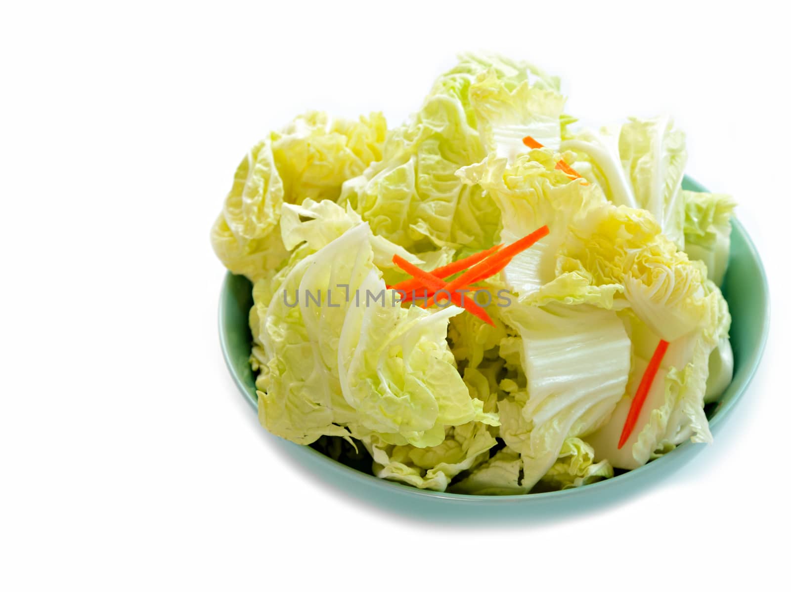 Slicing chinese cabbage and slicing carrot in dish isolated