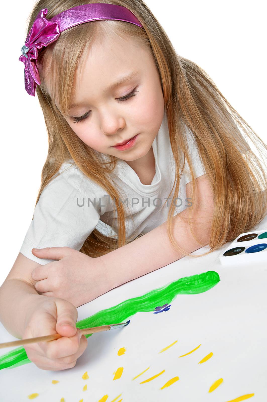 pretty little girl paints a watercolor painting