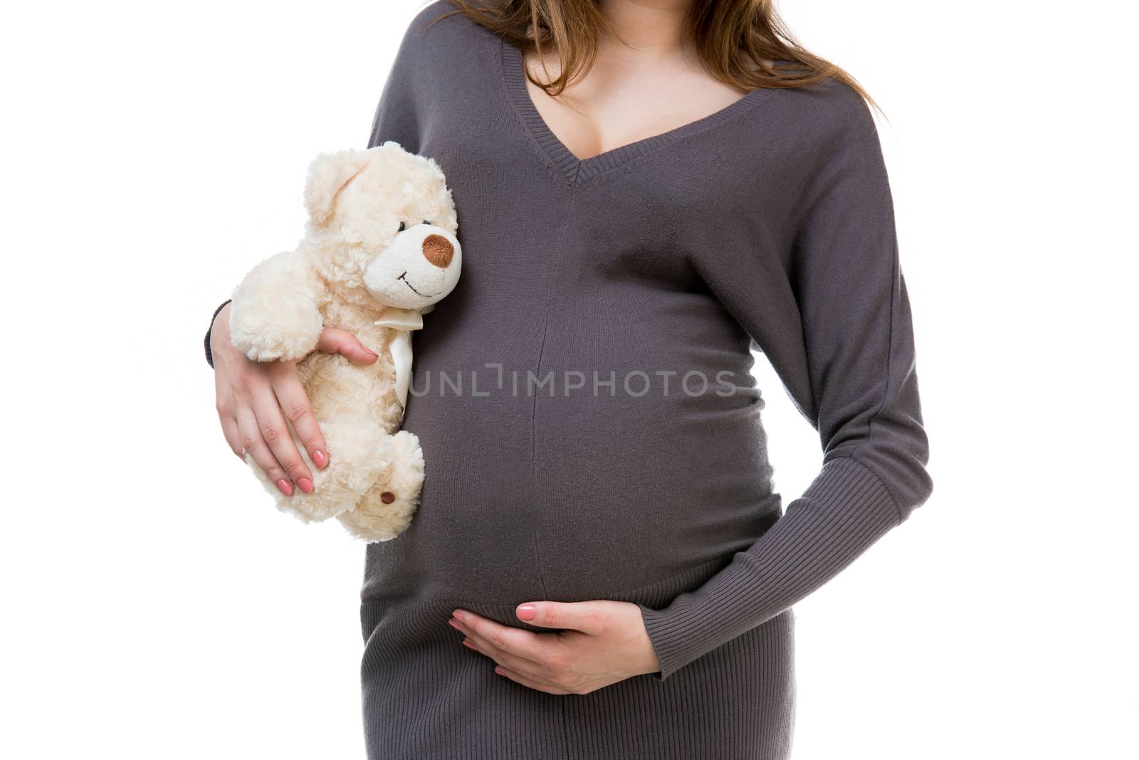 pregnant woman in a gray dress with a teddy bear isolated on white background
