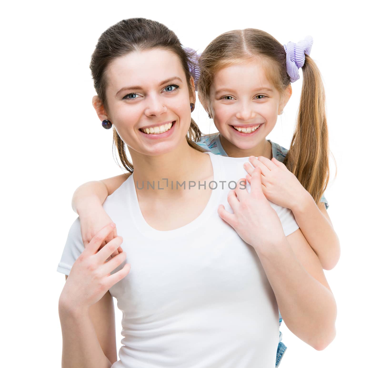 Smiling little girl embracing sister isolated over white background