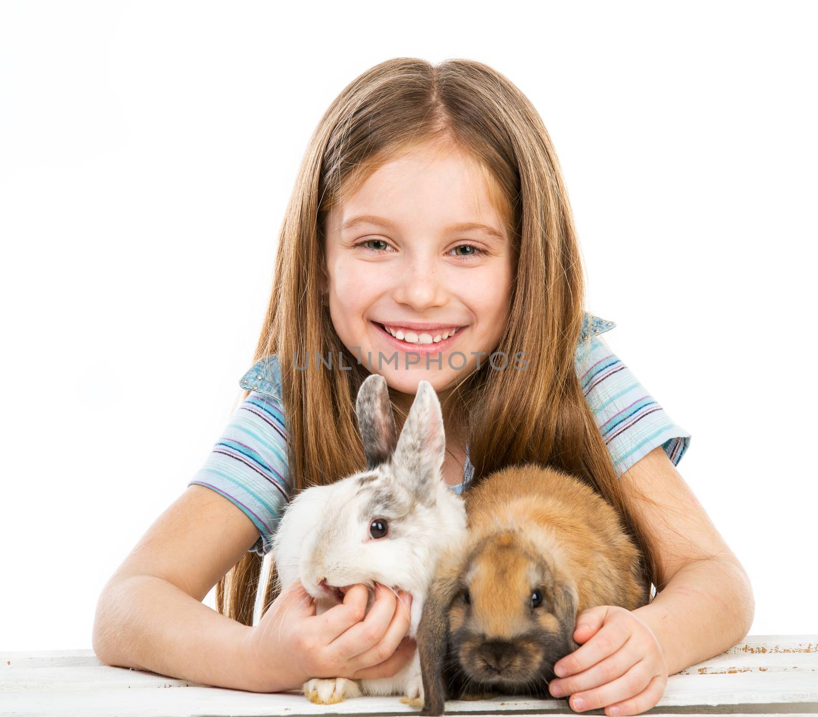 smiling little girl with two rabbits