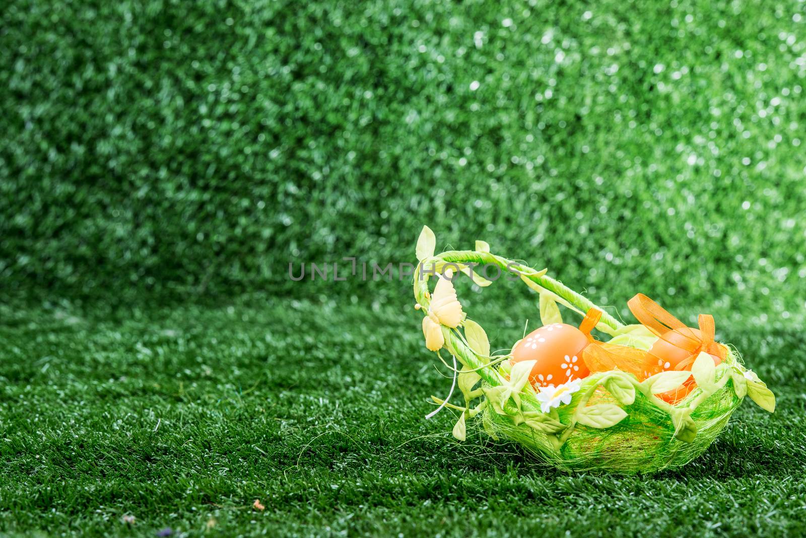 easter basket with eggs on a green background
