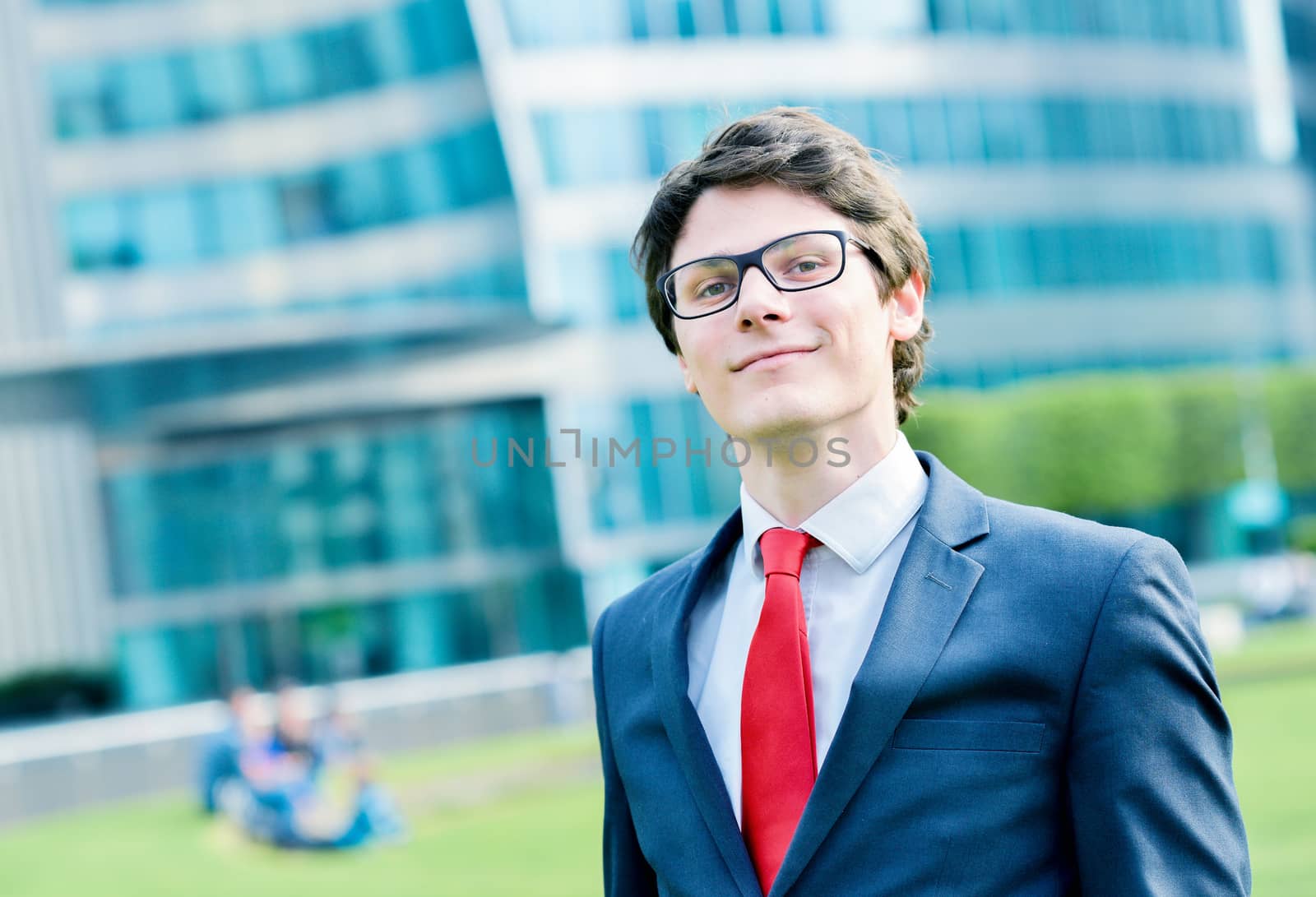 Outdoor portrait of a dynamic junior executive smiling