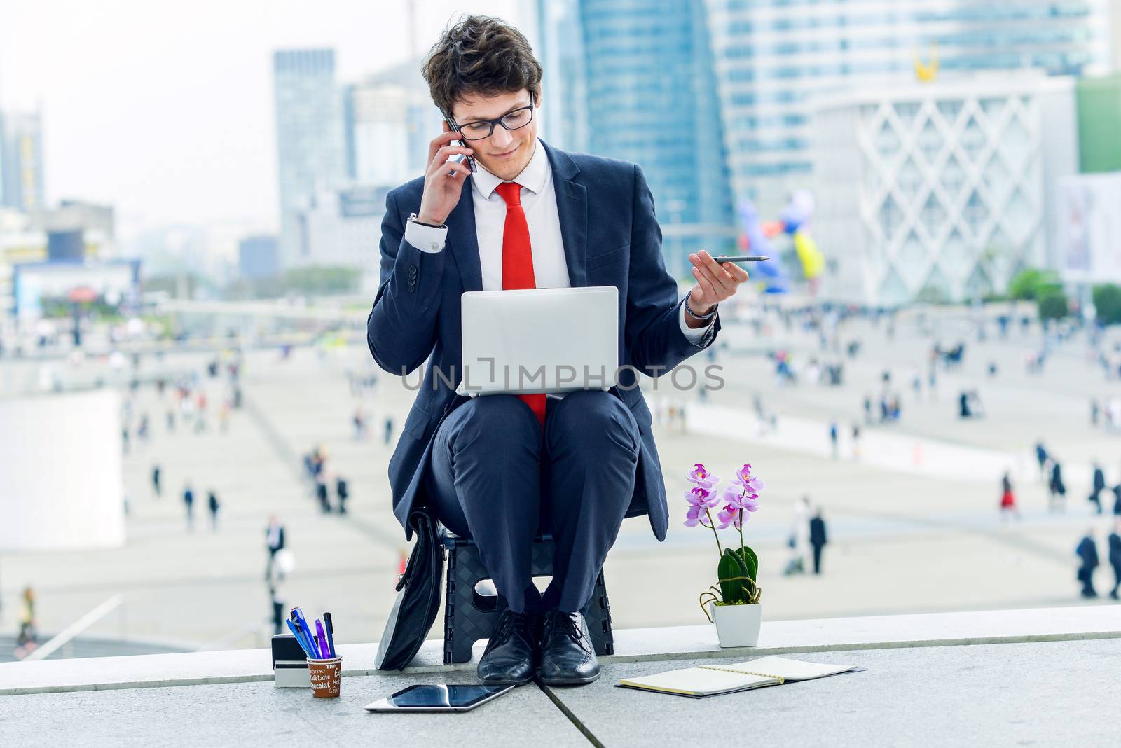 Junior executive dynamic phoning outside of his office