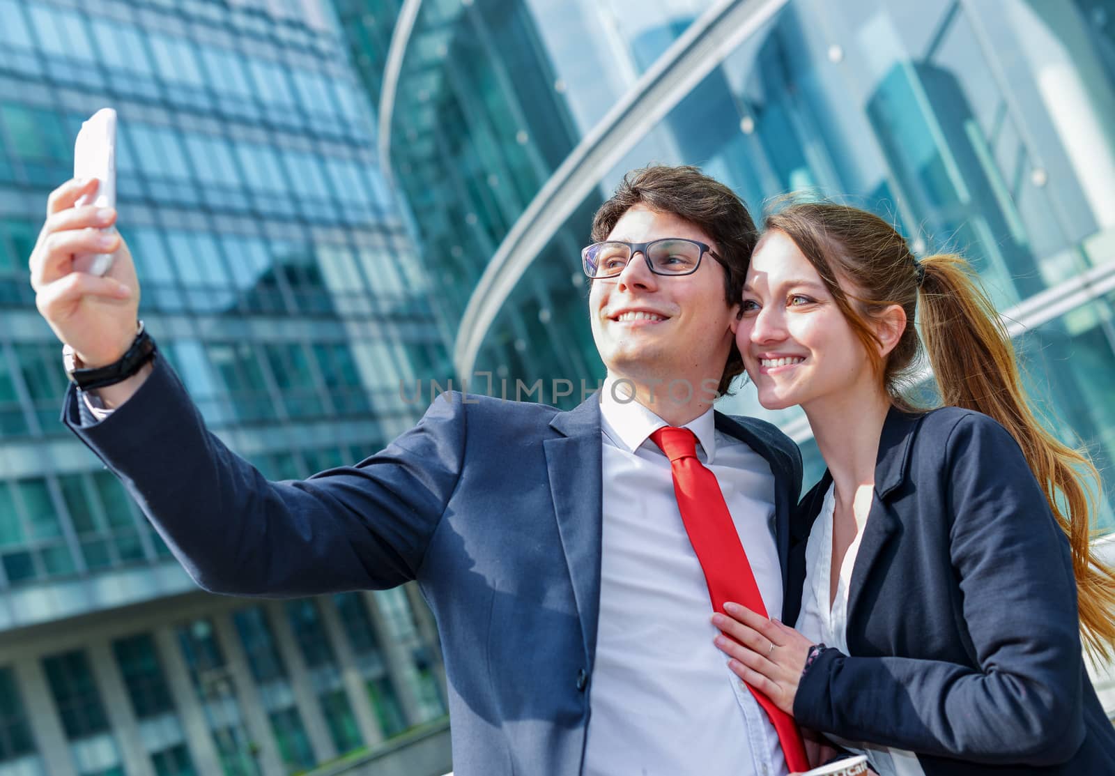 Young working colleagues photographing themselves