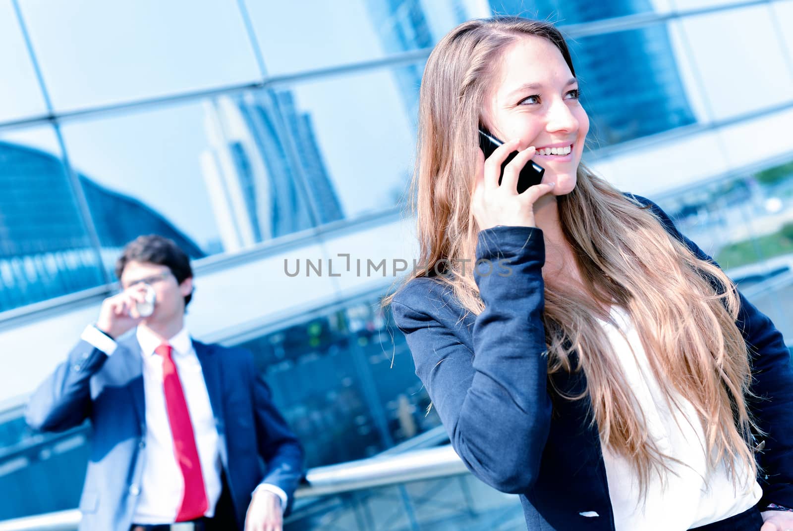 Junior executive dynamic phoning outside of her office