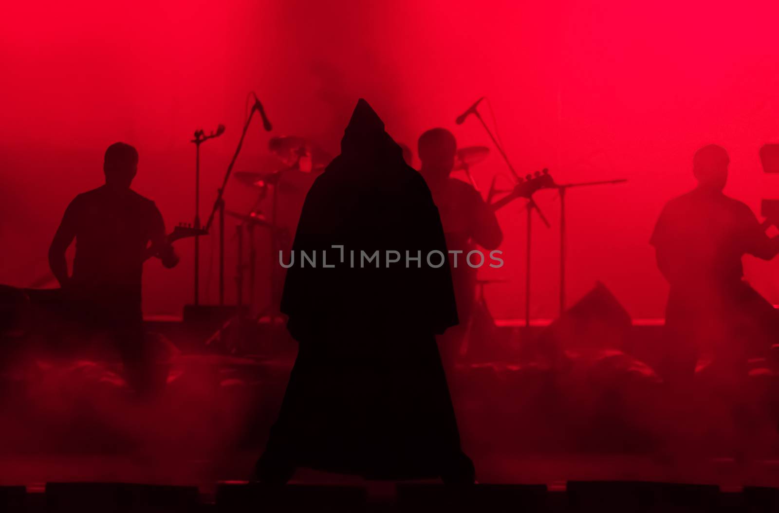 
Rock singer in the image of evil in a dark-red light 

