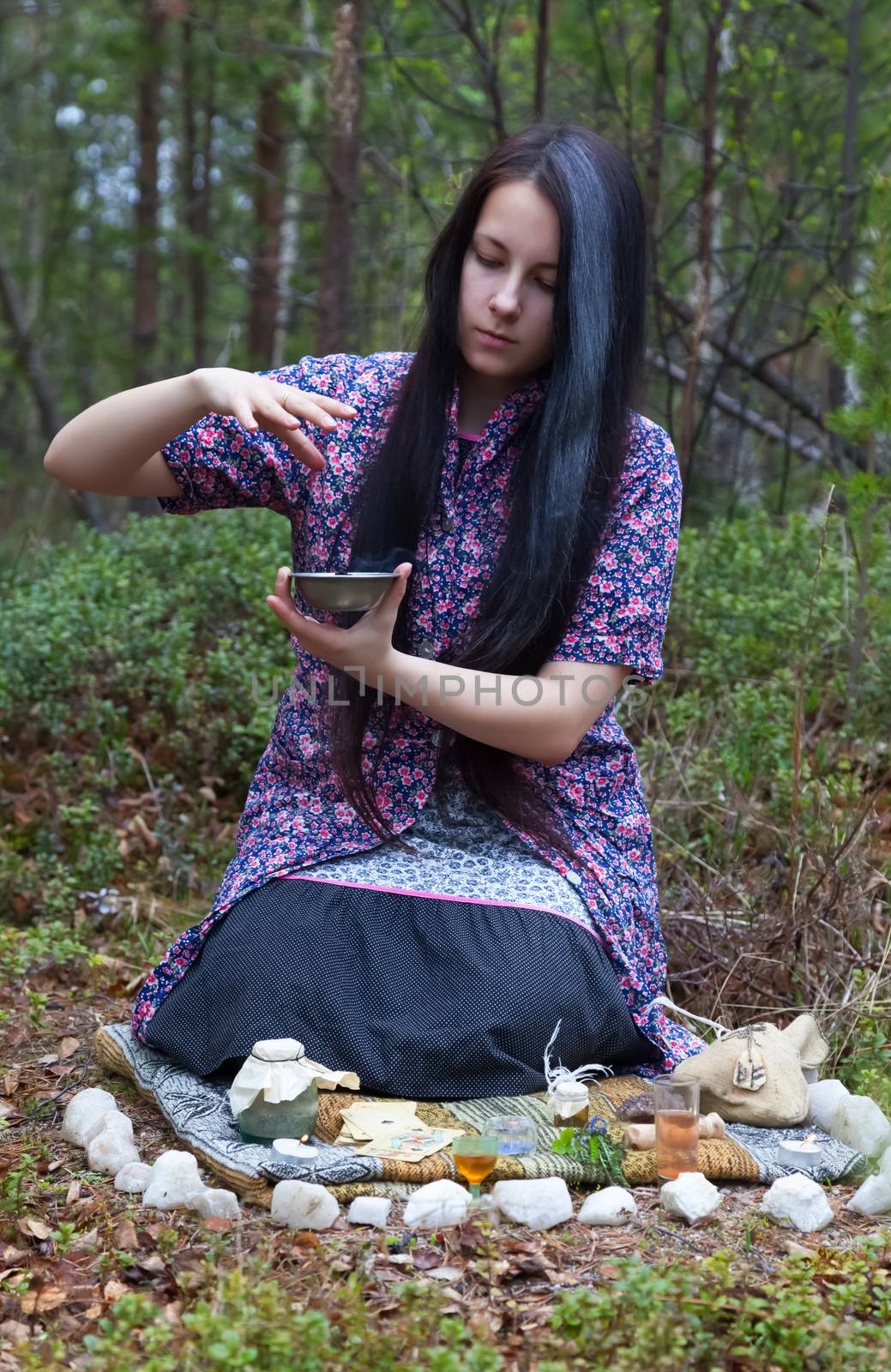 
Beautiful girl witch prepares witchcraft the drug in the woods 
