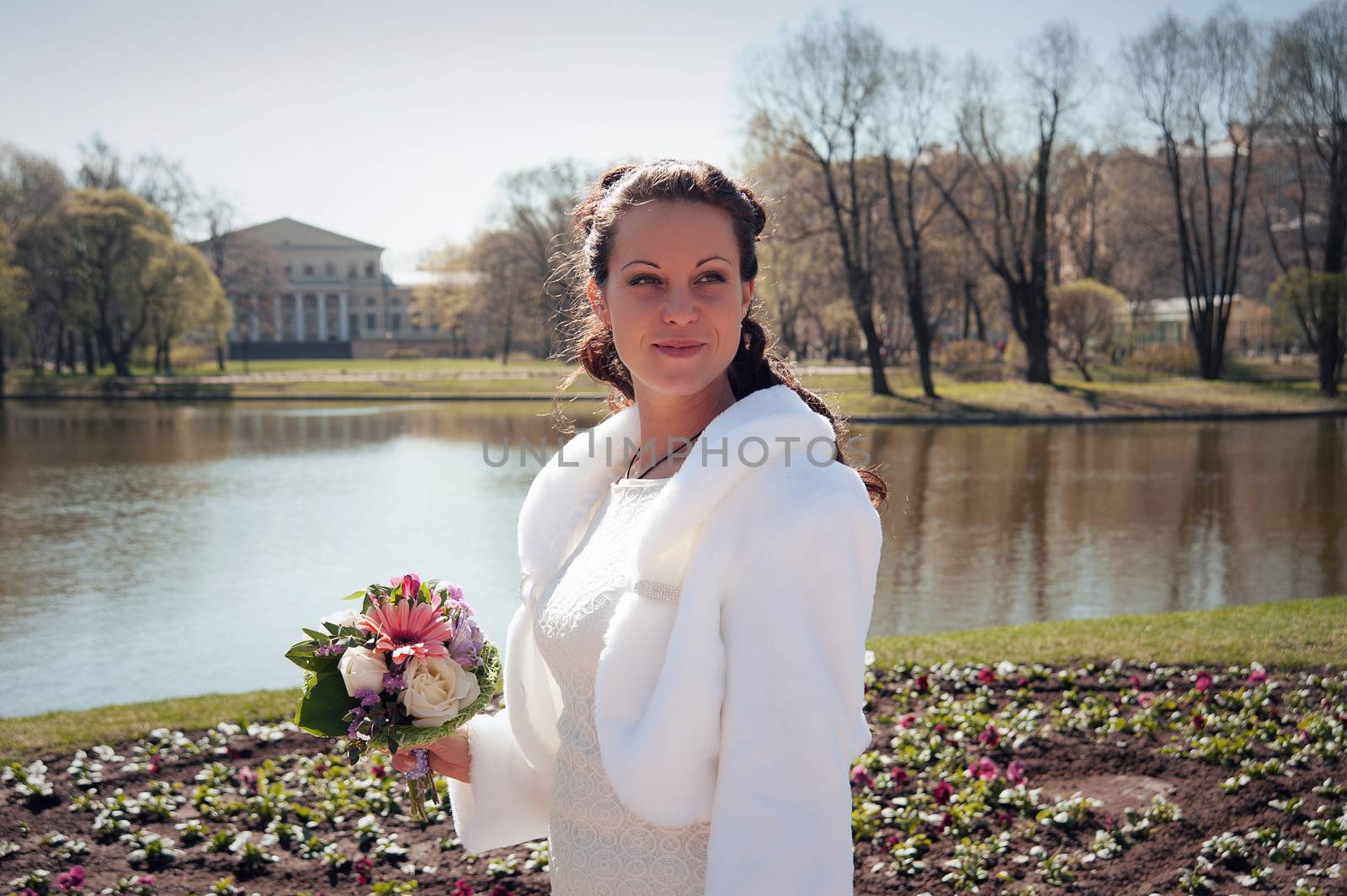 beautiful young bride with a bouquet in a Park in spring