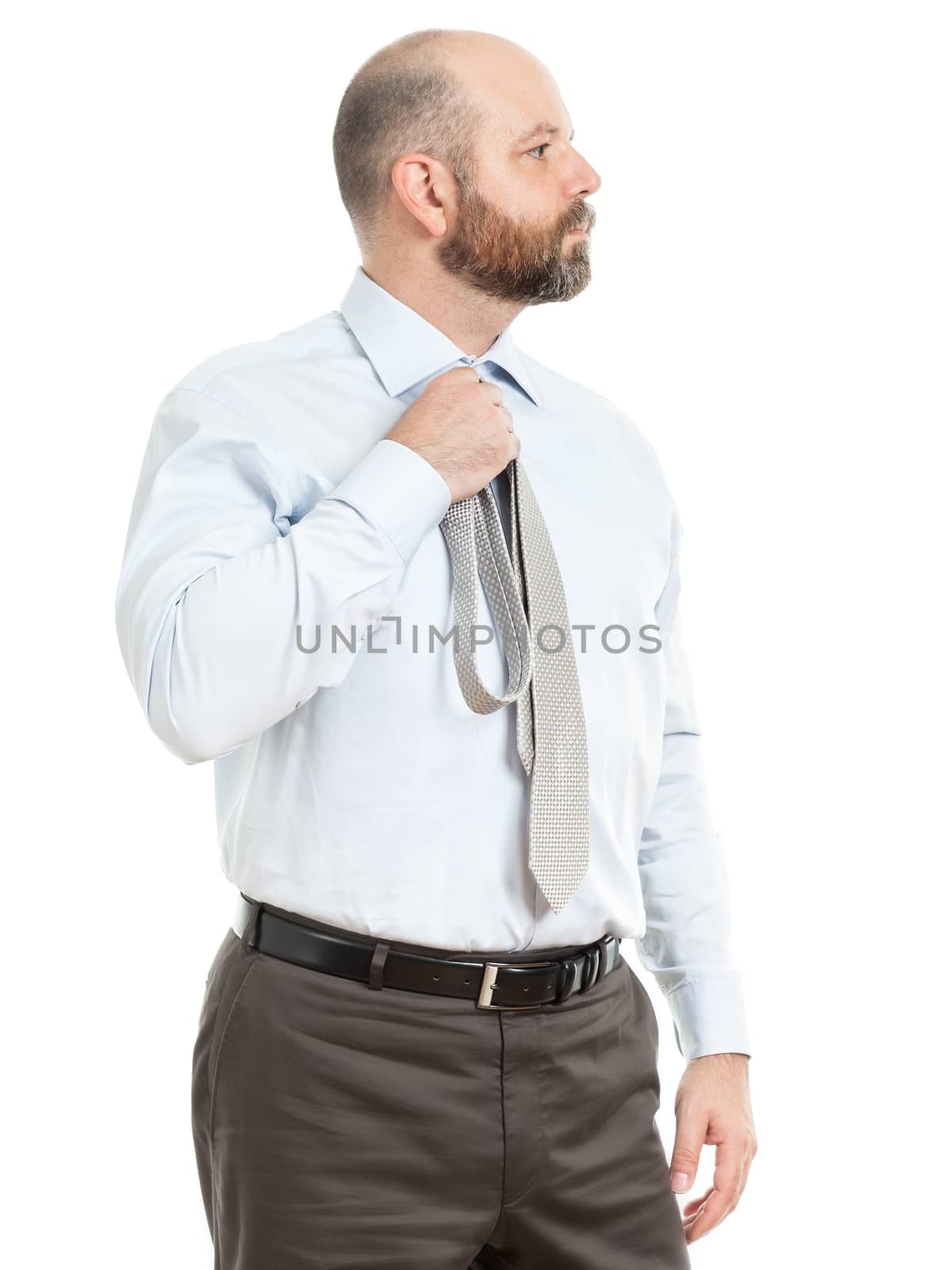 An image of a handsome business man who chooses a tie