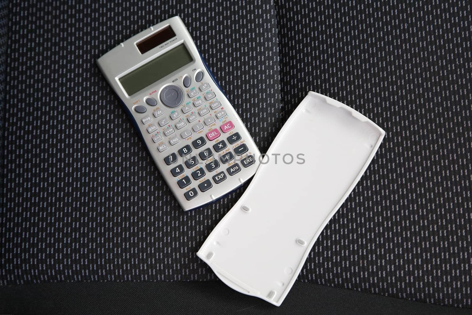 Scientific calculator on dark fabric