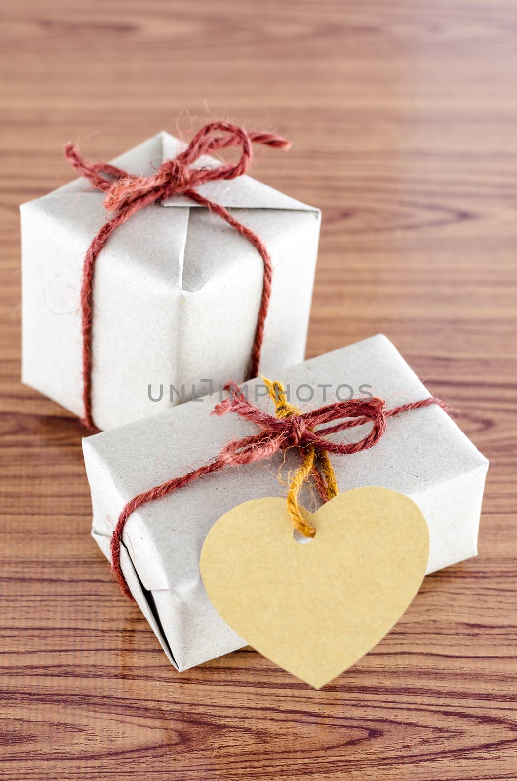 brown gift box with heart tag card on wood background