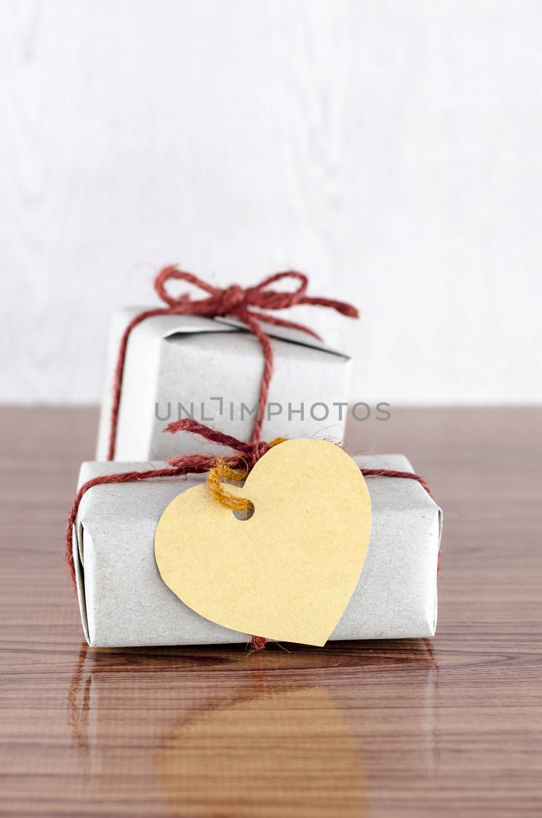 brown gift box with heart tag card on wood background