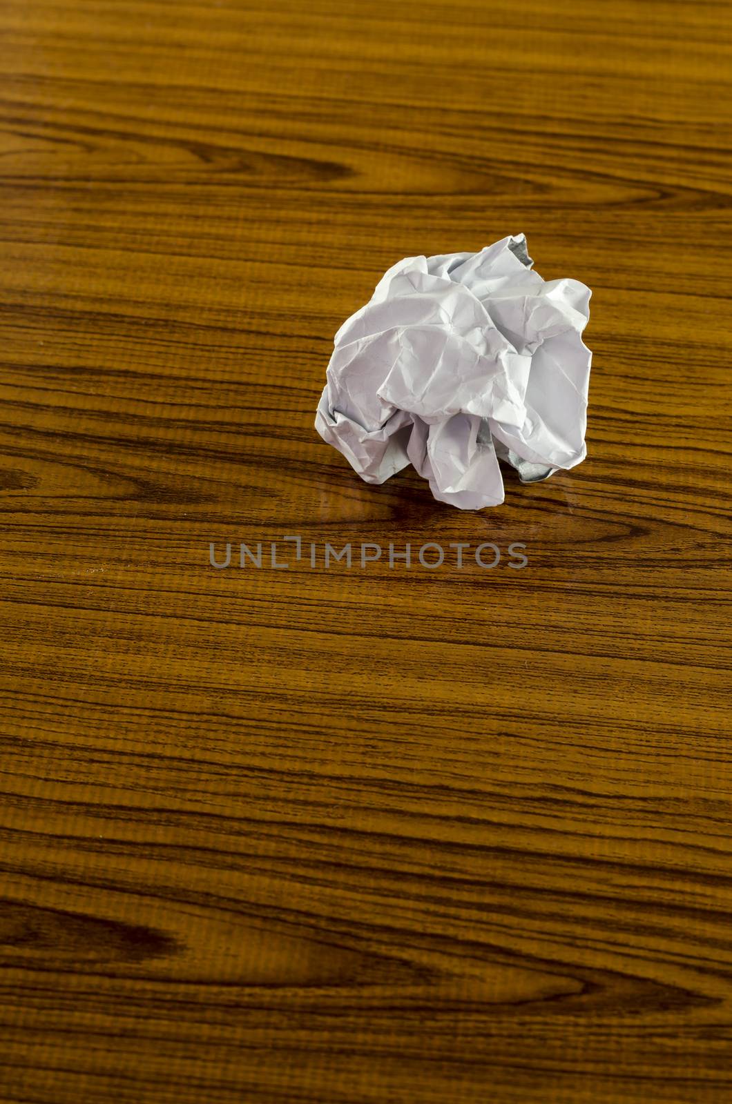 crumpled paper on wood background