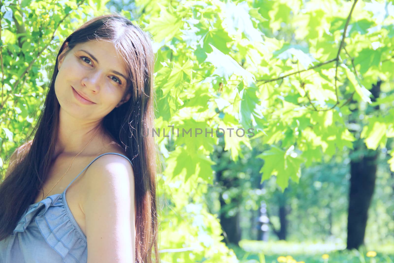 Happy beautiful woman with long hair in summer park