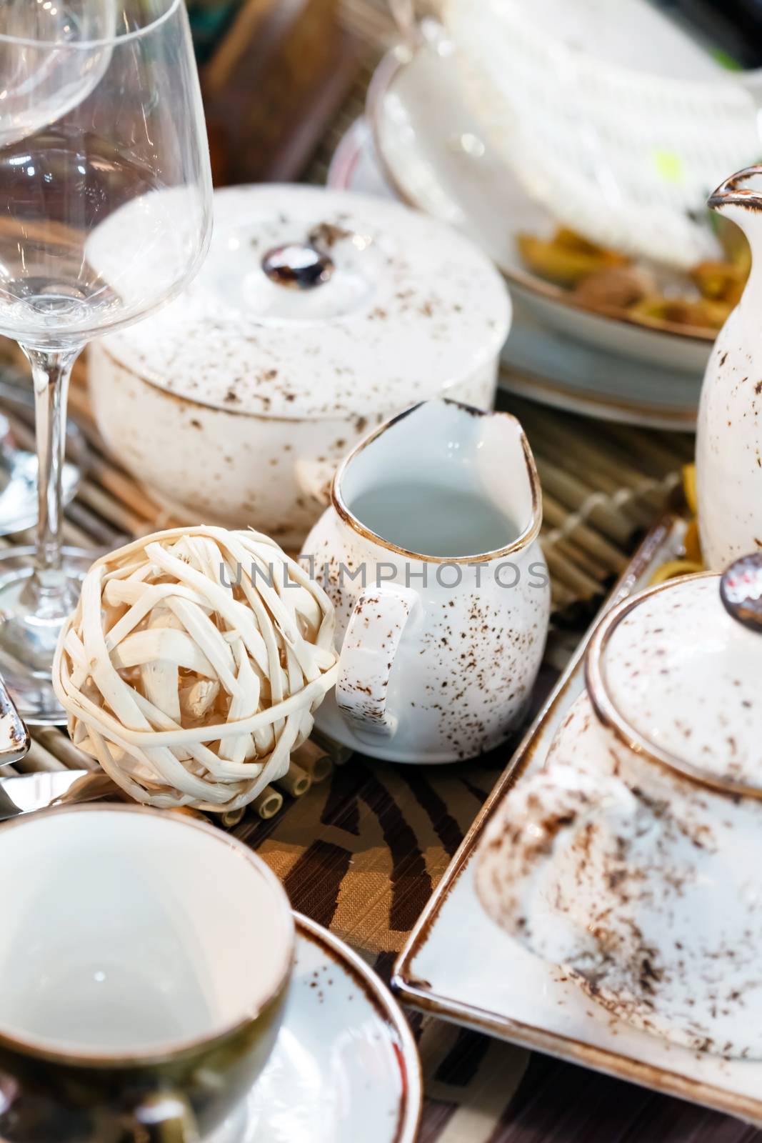 
Ceramic tableware on the table by shebeko