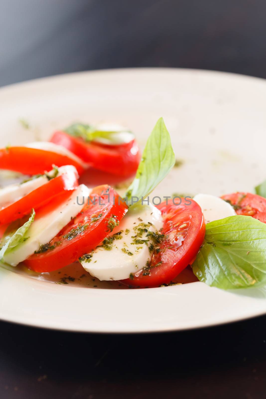 Tomato and mozzarella with basil leaves  by shebeko