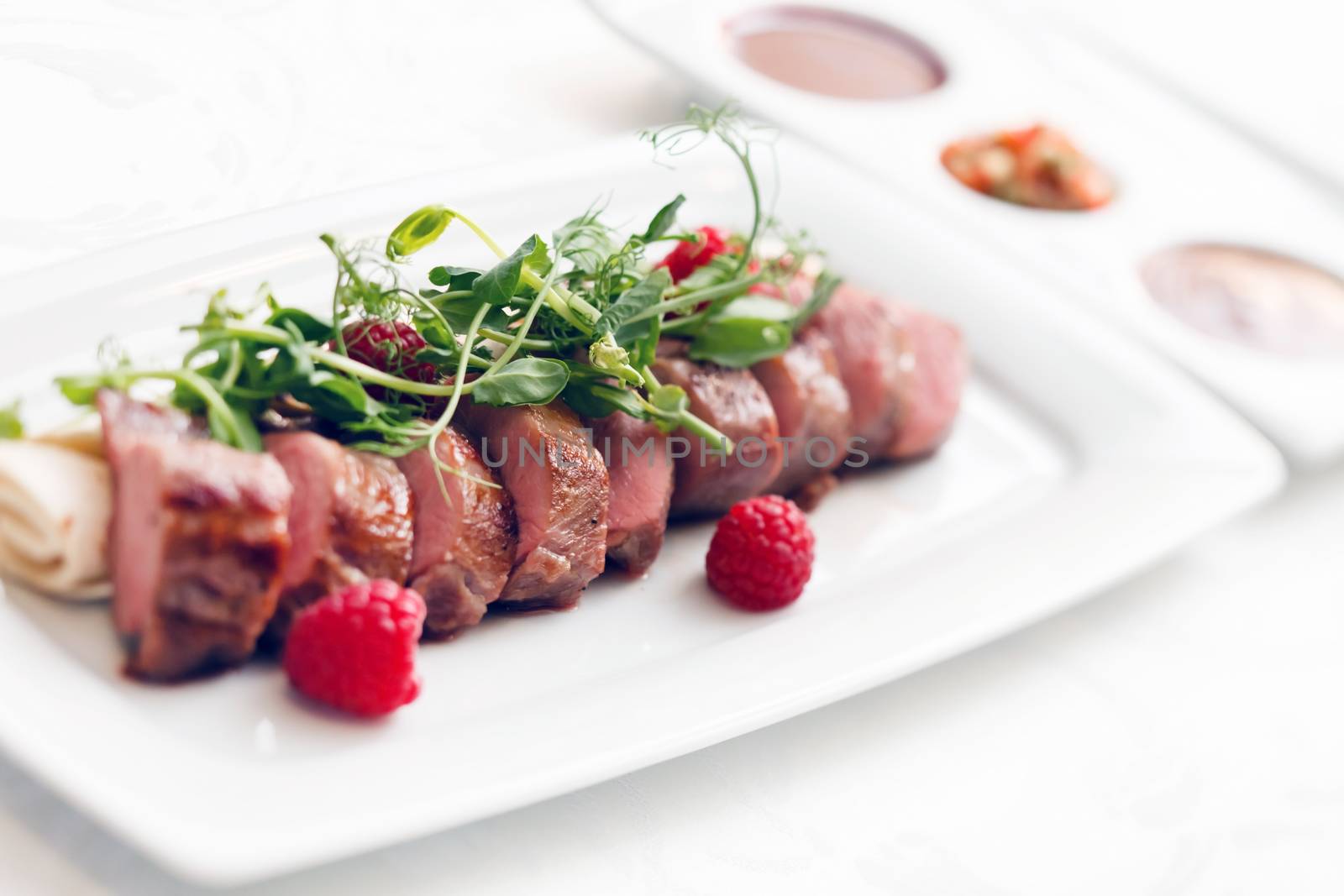 grilled duck breast covered with sweet red fruit sauce