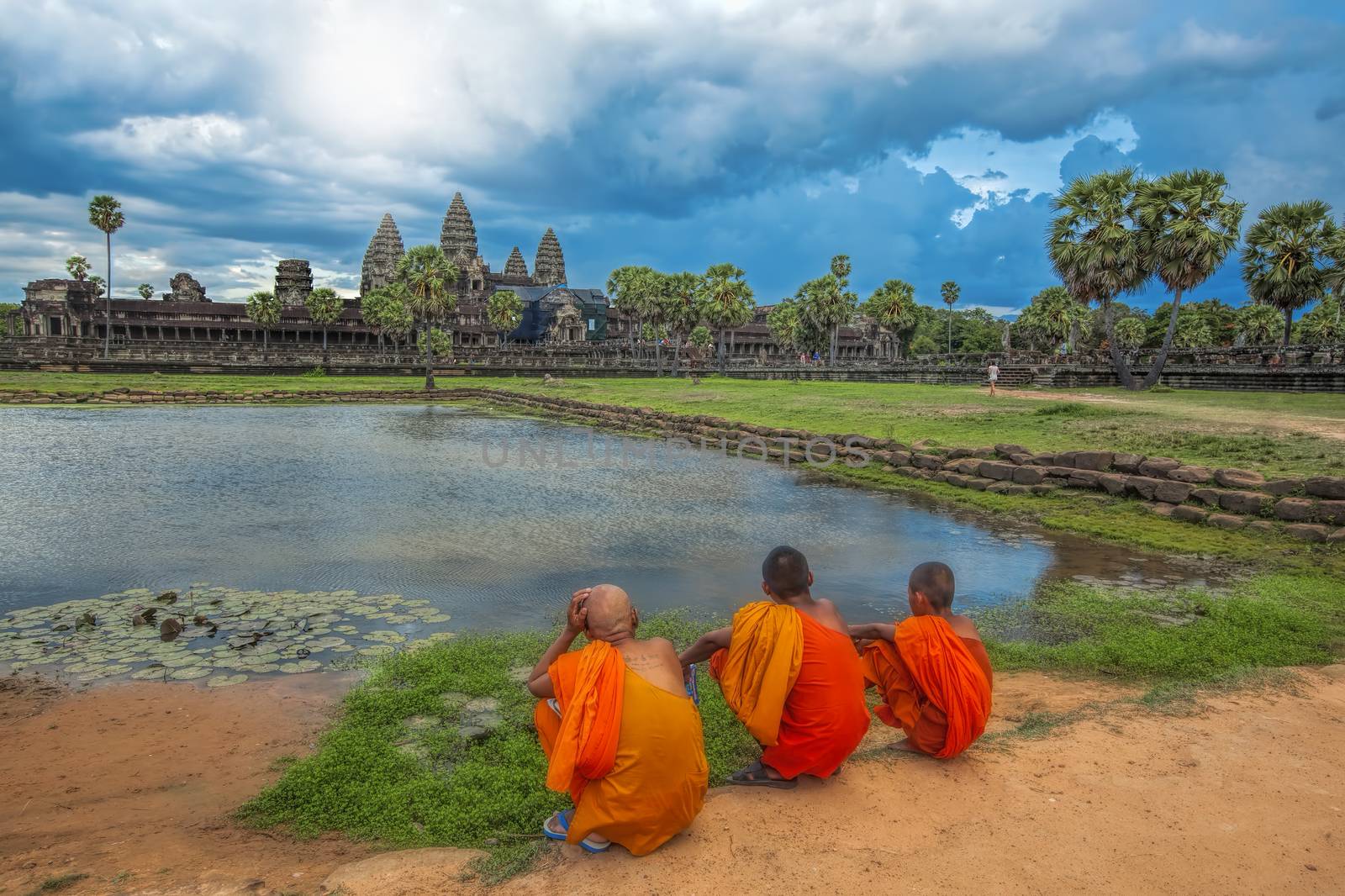 Monks watching the sunset over Angkor Wat from the lake