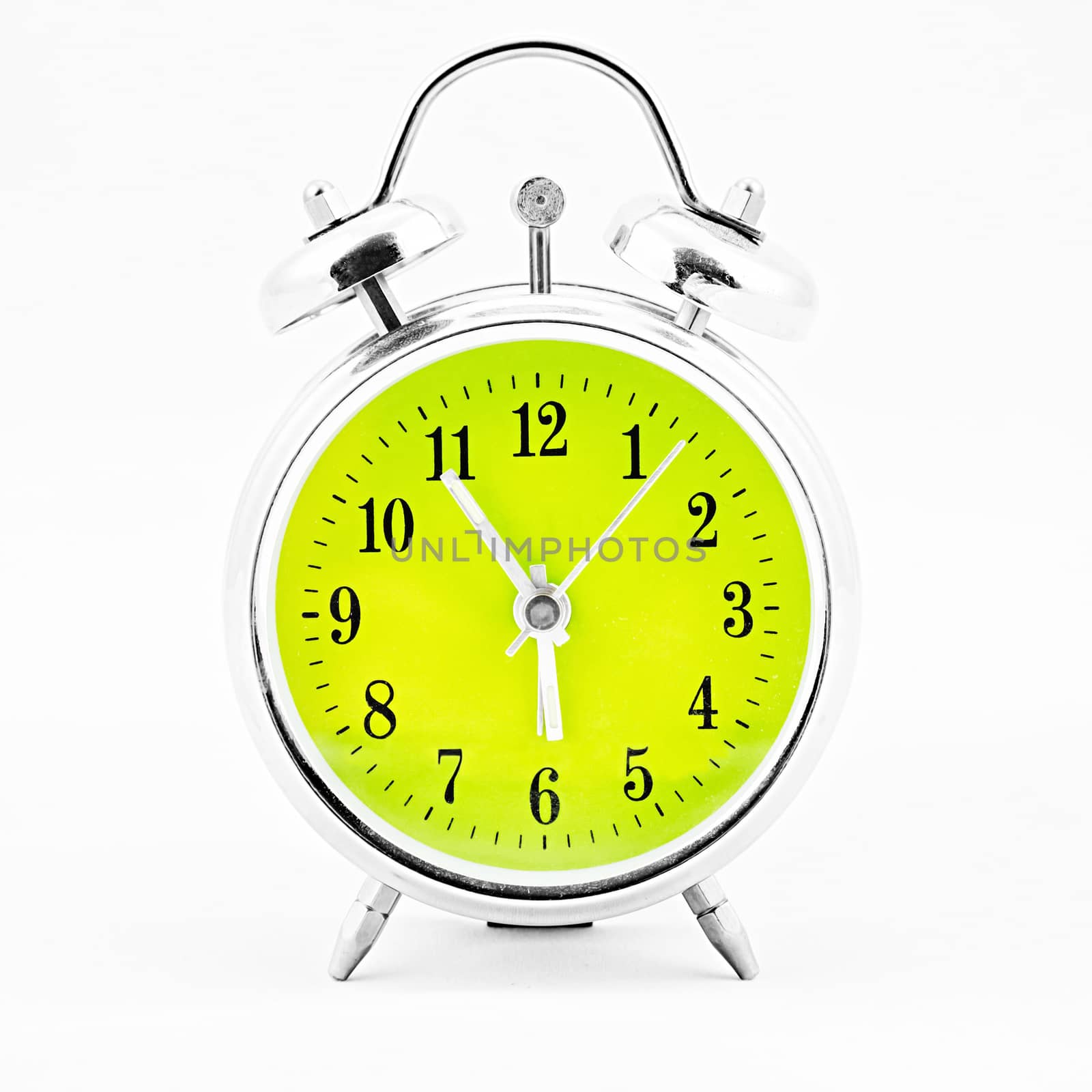 Alarm clock on white background. Showing time five minutes before six