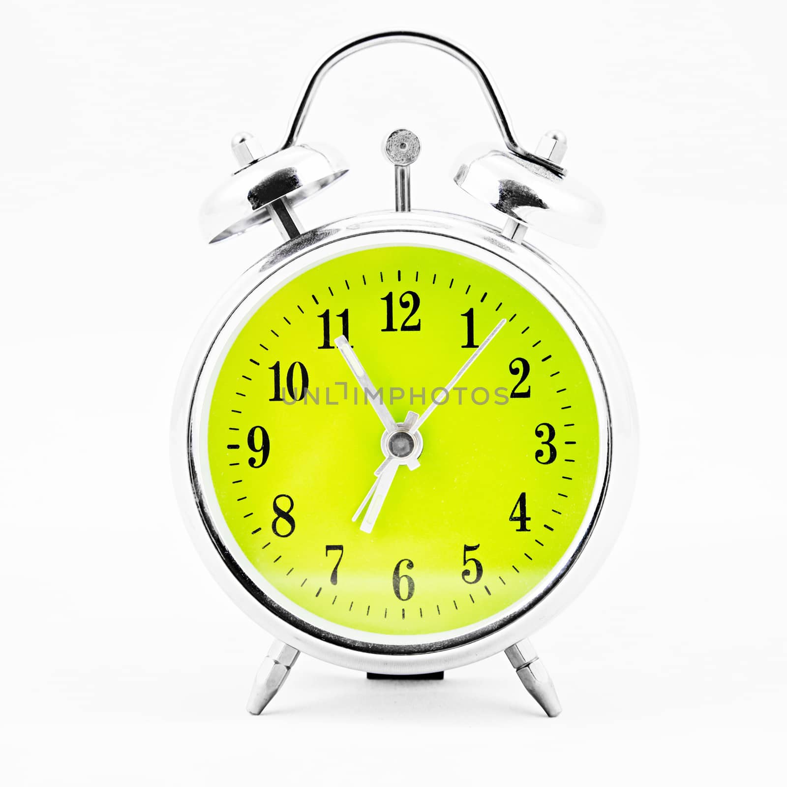 Alarm clock on white background. Showing time five minutes before seven
