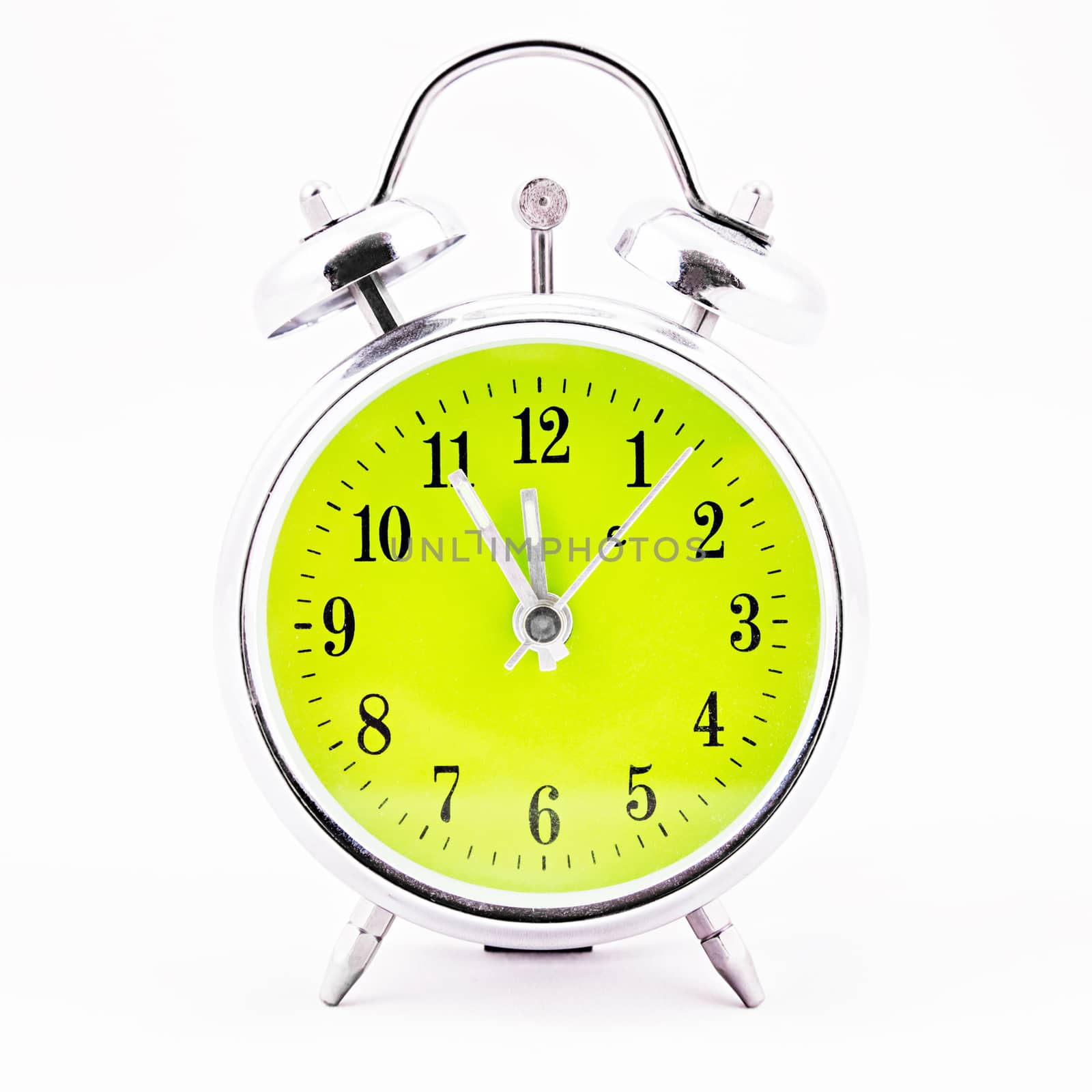 Alarm clock on white background. Showing time five minutes before twelve