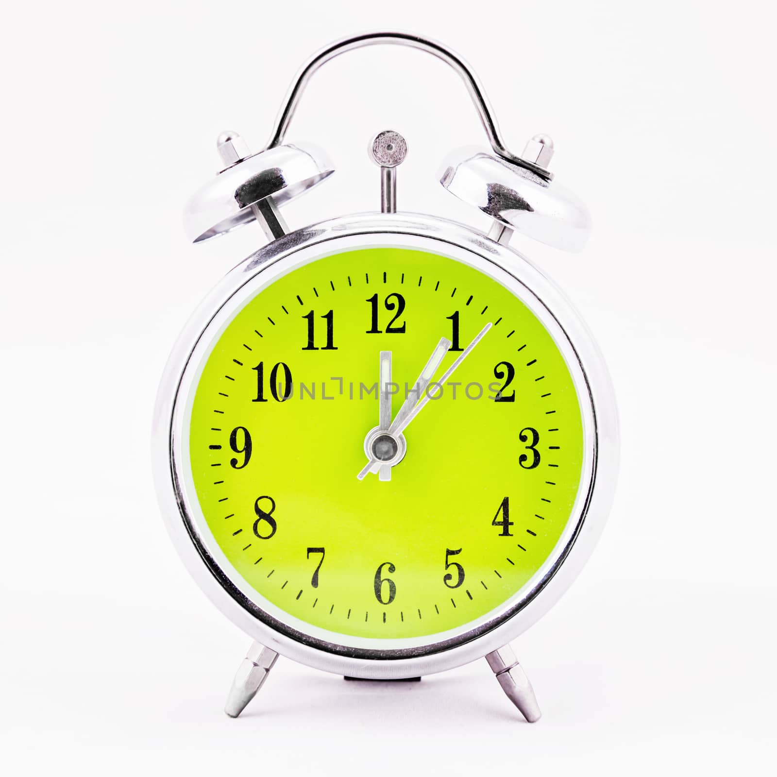 Alarm clock on white background. Showing time five minutes past twelve