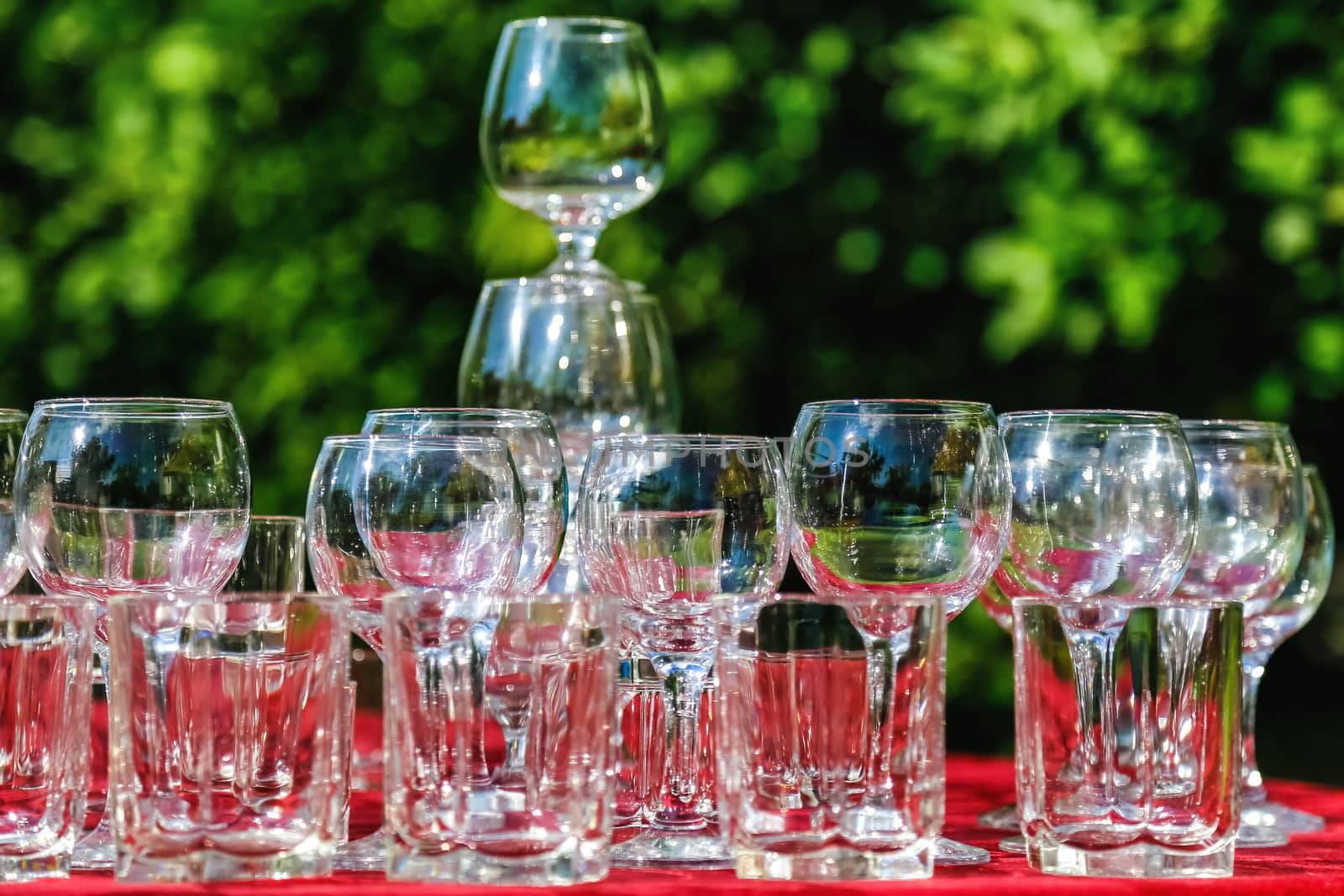 Empty wine glasses composition on table before celebration at outdoor