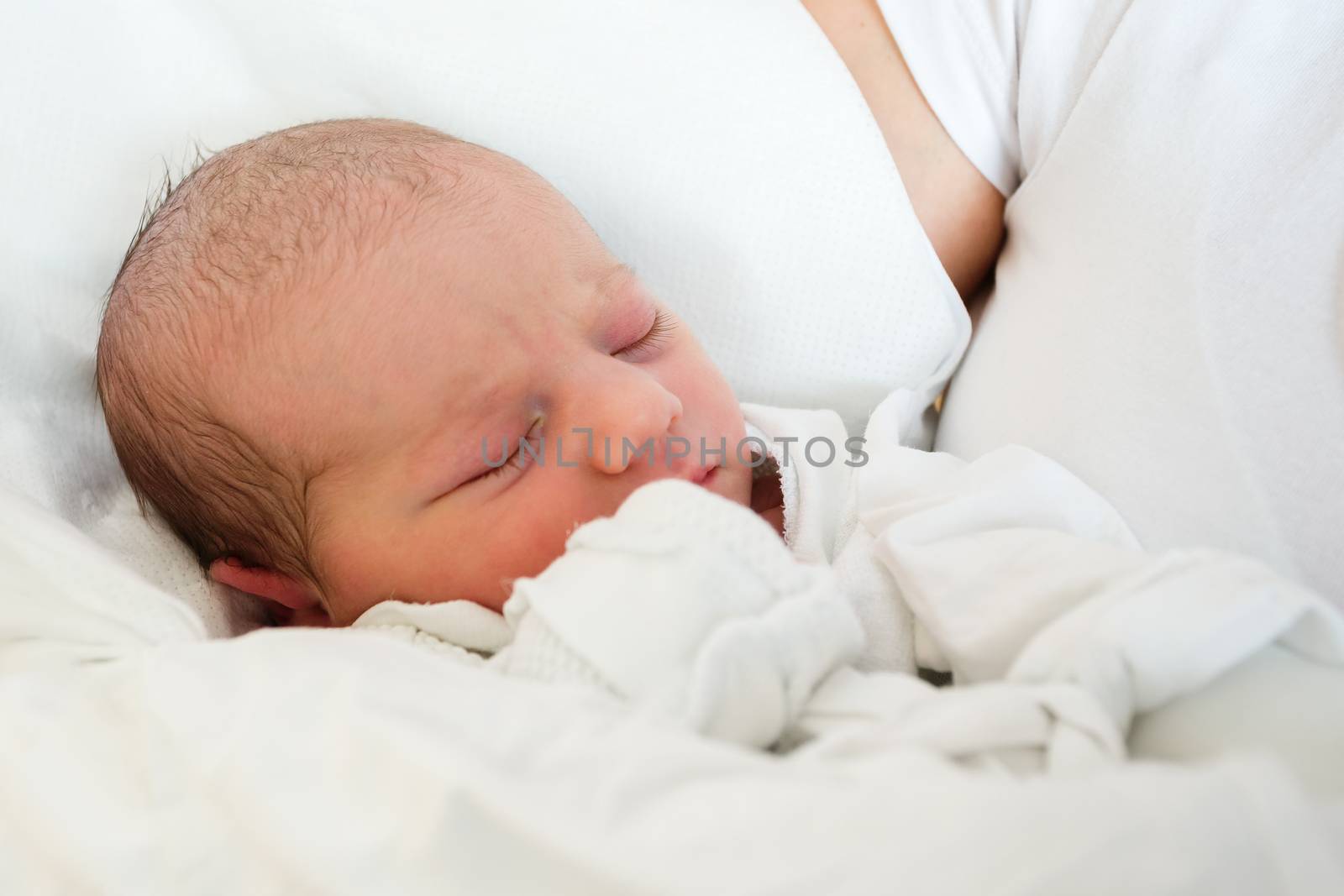 sleeping newborn baby in the hospital - the first hours of the new life