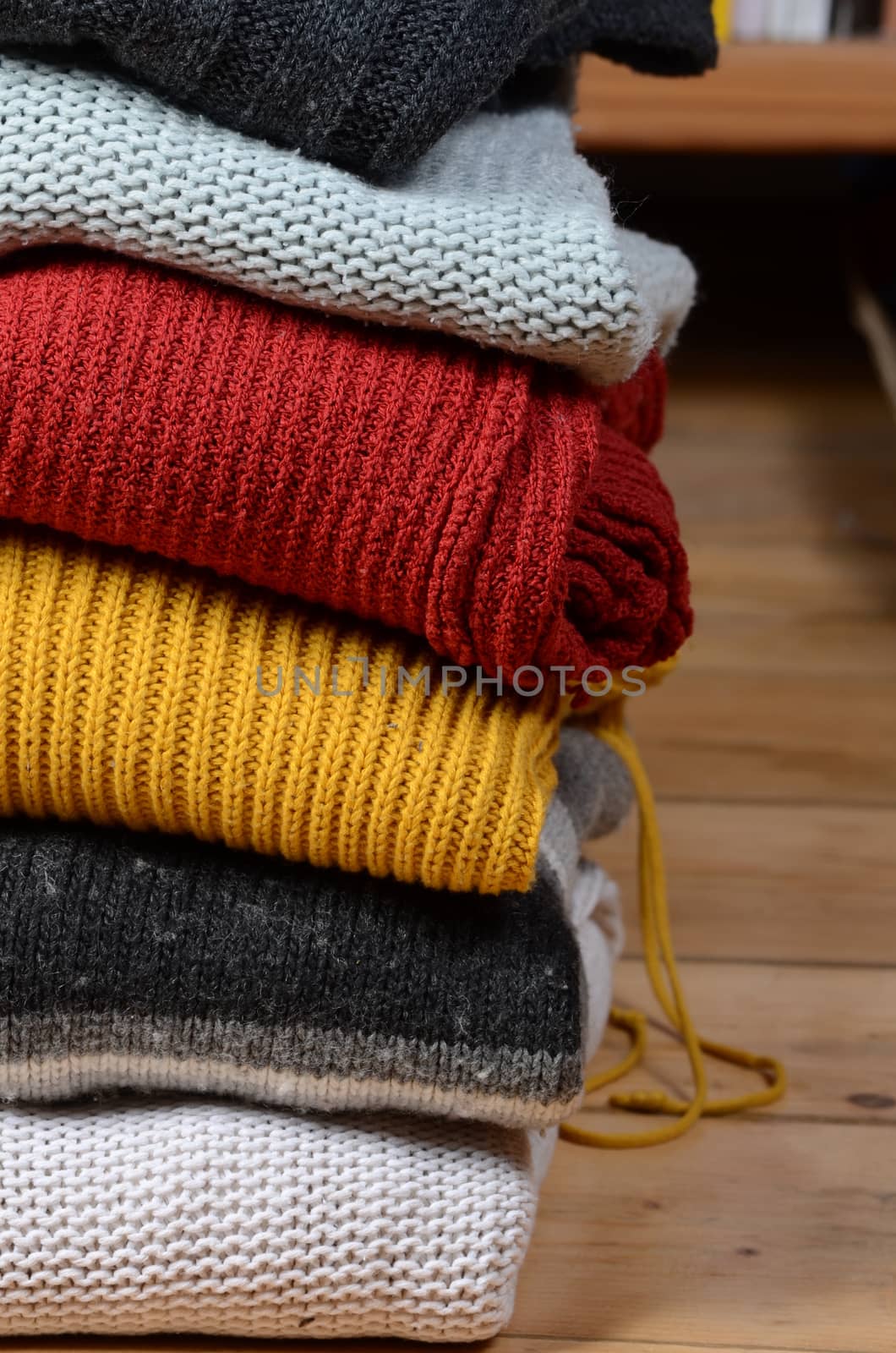 stack of sweaters by sarkao